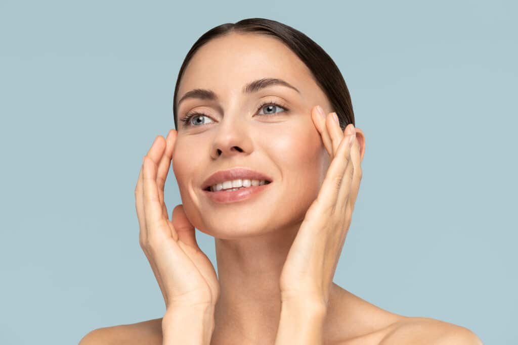 Woman touching her cheeks after Ameela treatment